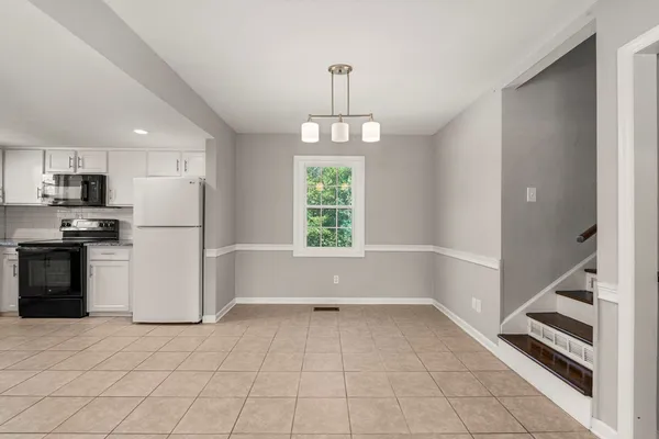 a view of a kitchen with a stove fridge and windows