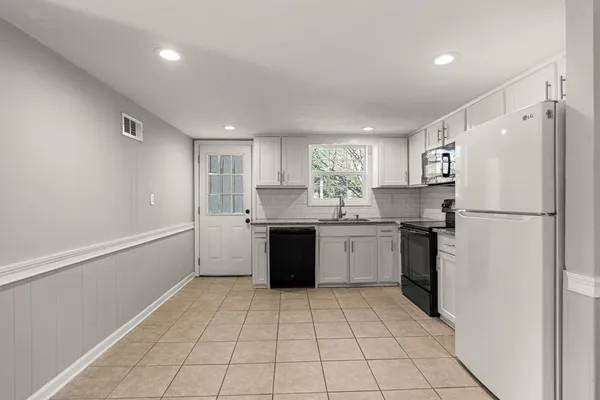 a kitchen with a refrigerator a sink and dishwasher