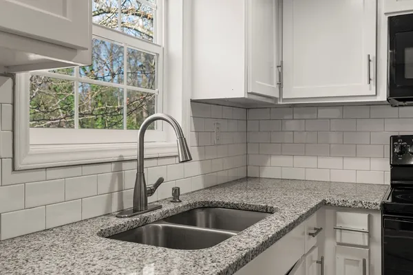 a kitchen with a sink and cabinets