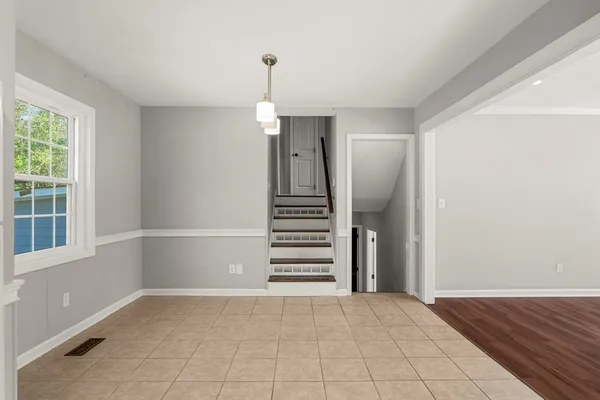 an empty room with windows and entryway