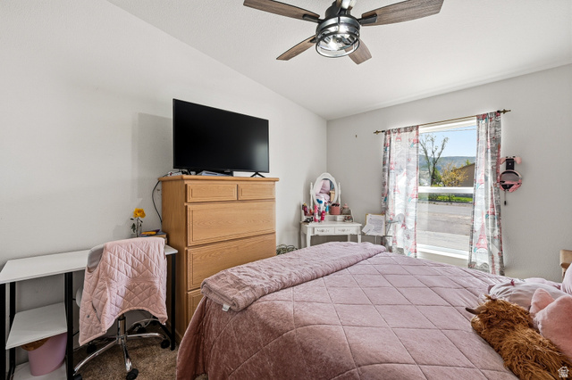 1637 East Midvalley Road Enoch, UT 84721 - Photo 25 of 48 Bedroom featuring vaulted ceiling, ceiling fan, and carpet flooring