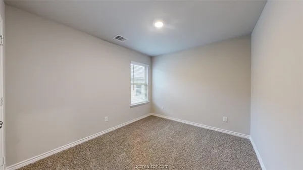 a view of an empty room and a window