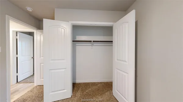 a view of hallway with wooden floor