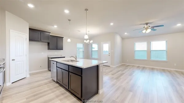 an open kitchen with a sink and dish washer
