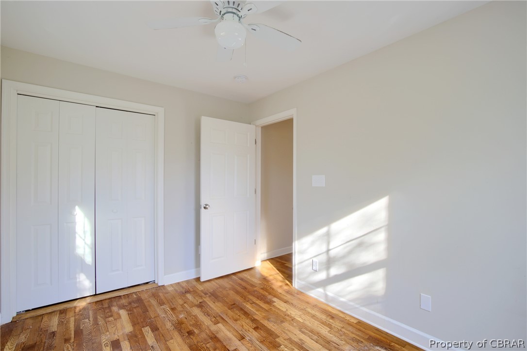 5347 Ware Neck Road Gloucester, VA 23061 - Photo 13 of 36 Unfurnished bedroom featuring ceiling fan, a closet, and light wood-type flooring
