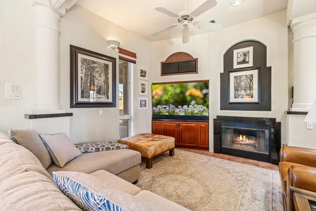 a view of a swimming pool with lawn chairs under an umbrella