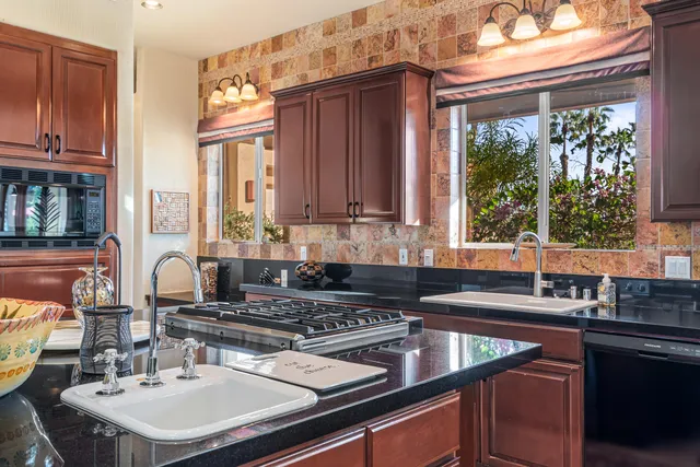 a patio with a table and chairs a barbeque