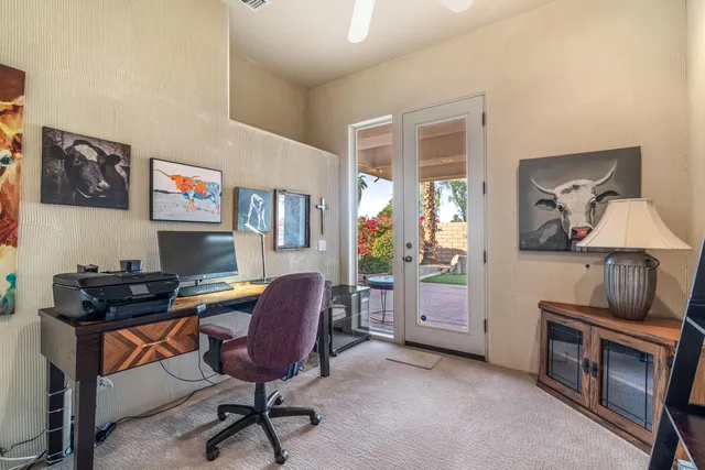 a view of front of house with palm trees