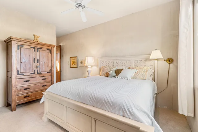 a front view of a house with garden and trees