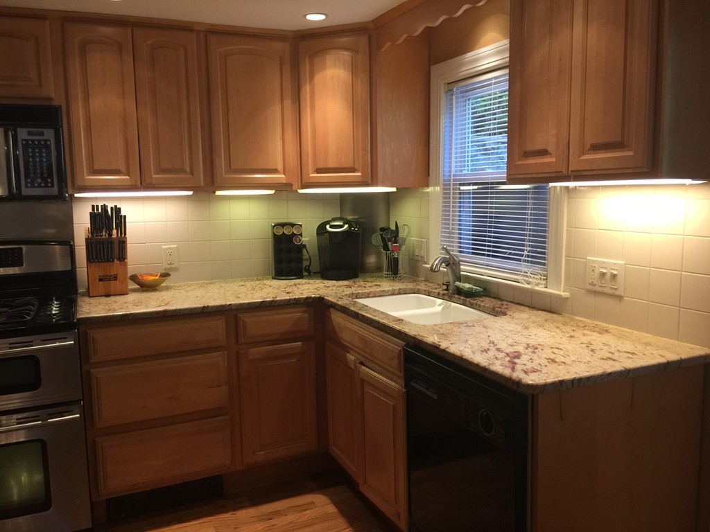 30 Tinson Road Quincy, MA 02169 - Photo 5 of 10 a kitchen with granite countertop cabinets sink and stove