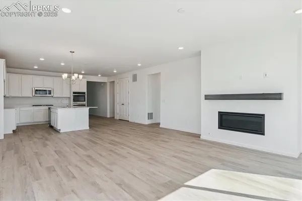 a view of a kitchen with a sink and a fireplace