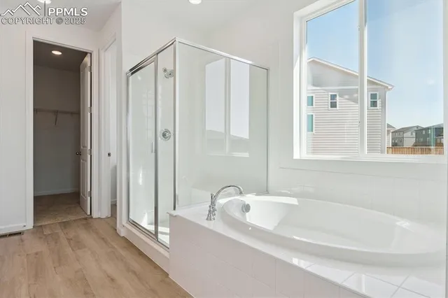 a bathroom with a bathtub and a shower