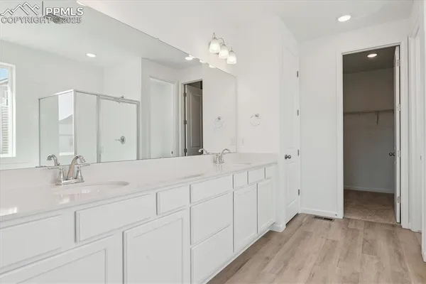 a bathroom with a double vanity sink and a mirror