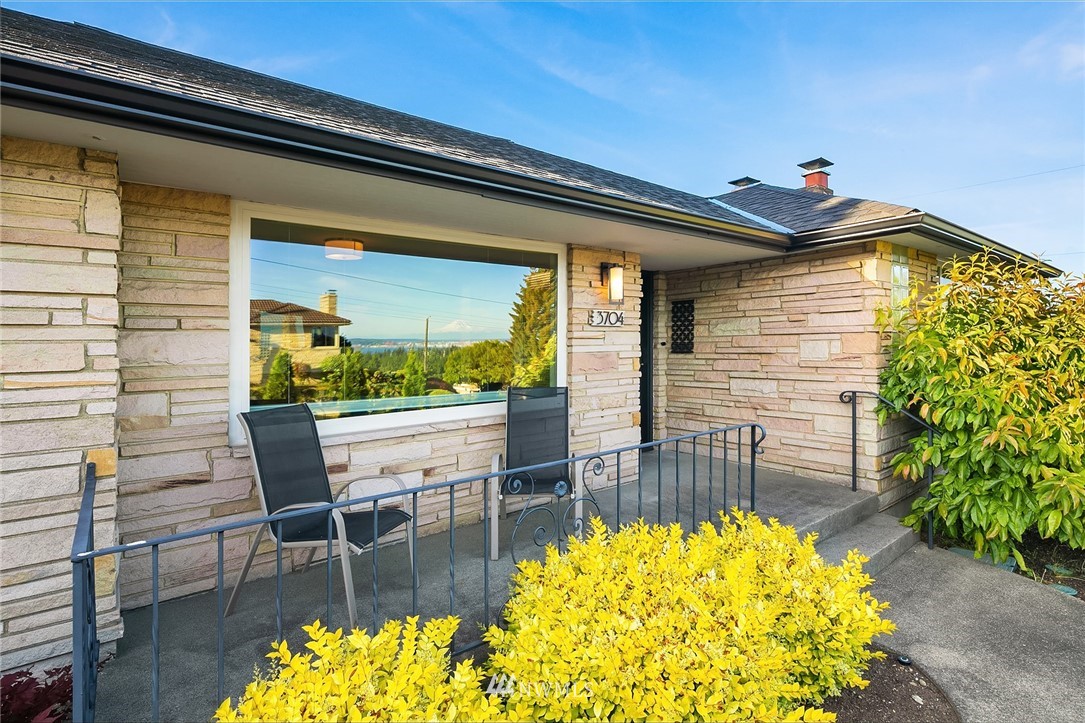 a view of a chairs and table in the balcony