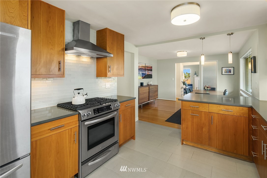 3704 West Dravus Street Seattle, WA 98199 - Photo 11 of 35 a kitchen with stainless steel appliances granite countertop a stove and a sink