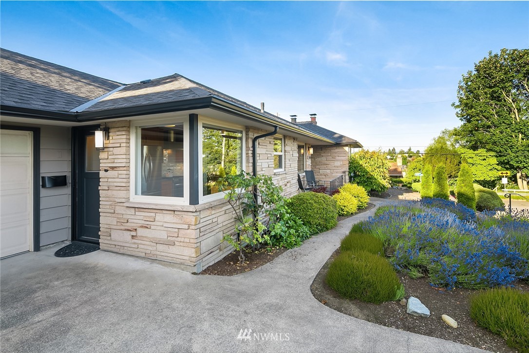 3704 West Dravus Street Seattle, WA 98199 - Photo 12 of 35 a front view of a house with garden