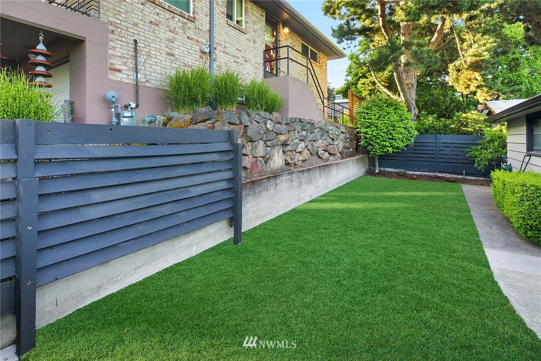 3704 West Dravus Street Seattle, WA 98199 - Photo 14 of 35 a backyard of a house with lots of green space