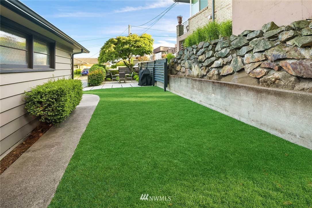 3704 West Dravus Street Seattle, WA 98199 - Photo 15 of 35 a view of a garden with a fountain