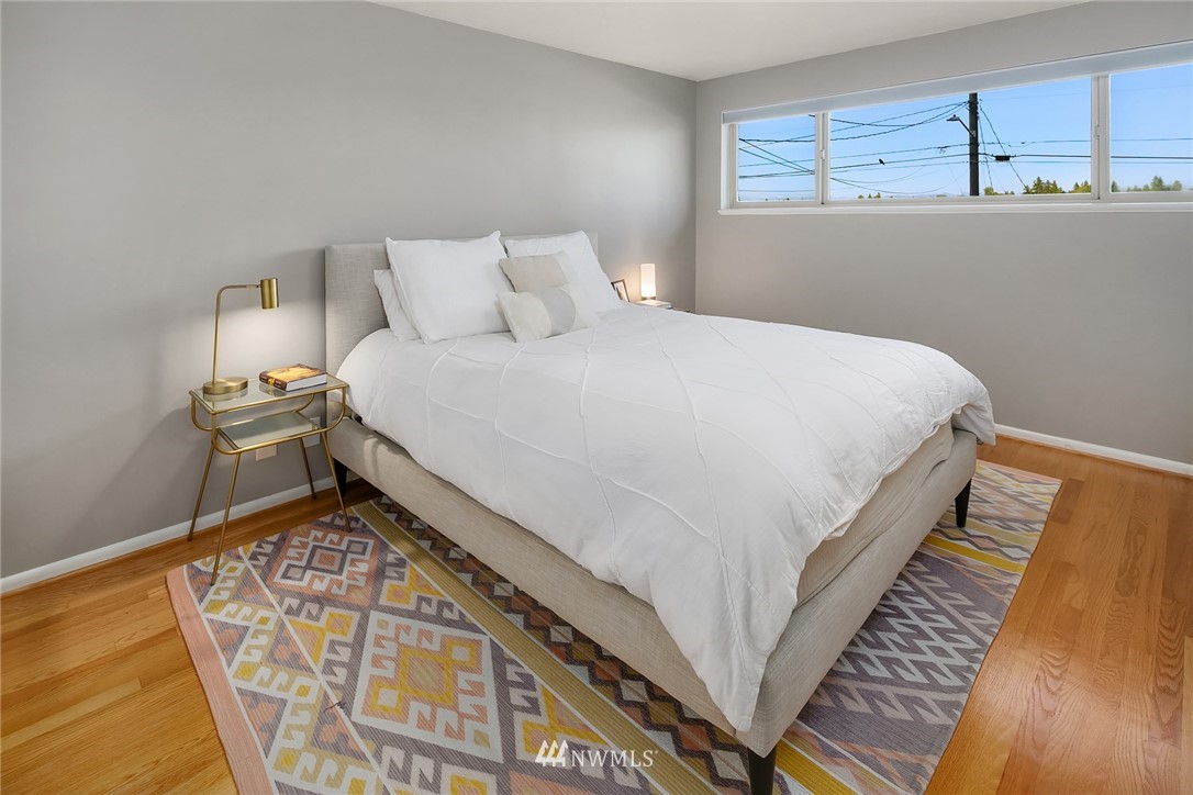 3704 West Dravus Street Seattle, WA 98199 - Photo 17 of 35 a bed sitting in a bedroom next to a window