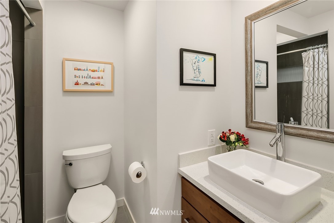 3704 West Dravus Street Seattle, WA 98199 - Photo 21 of 35 a bathroom with a sink mirror and toilet