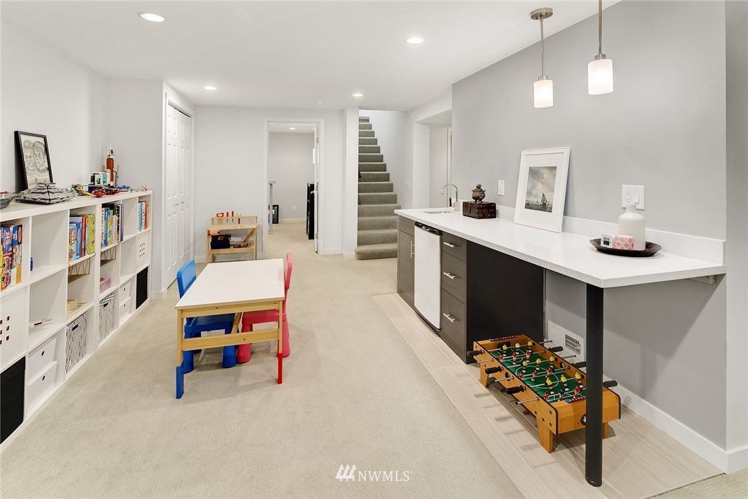 3704 West Dravus Street Seattle, WA 98199 - Photo 23 of 35 a living room with furniture and a flat screen tv