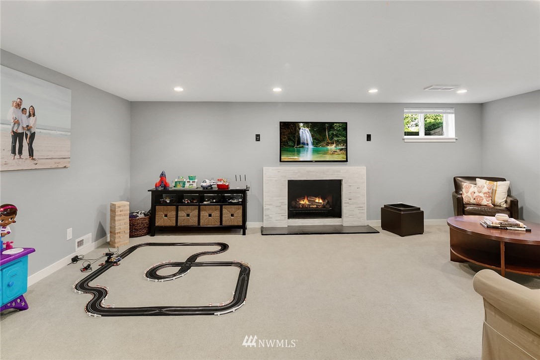 3704 West Dravus Street Seattle, WA 98199 - Photo 25 of 35 a living room with furniture and a fireplace