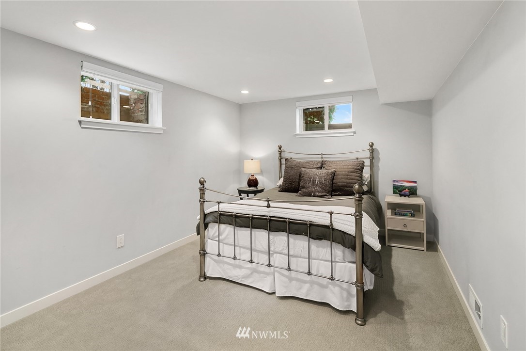 3704 West Dravus Street Seattle, WA 98199 - Photo 27 of 35 a bedroom with a bed and a night stand
