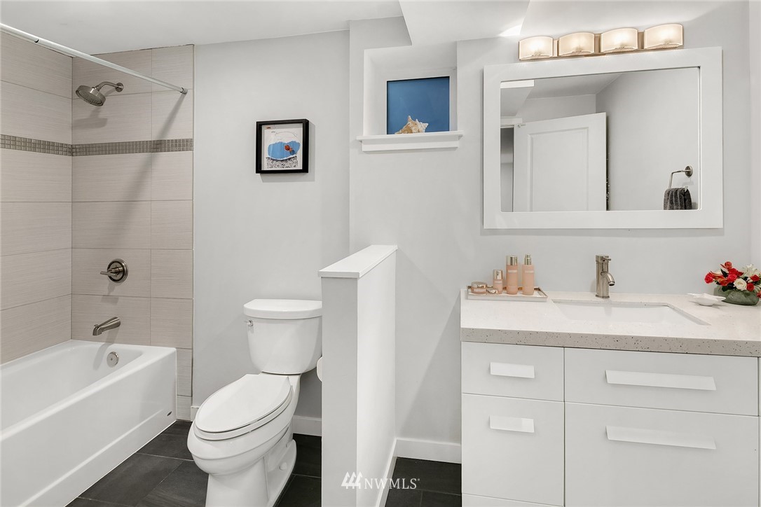 3704 West Dravus Street Seattle, WA 98199 - Photo 28 of 35 a bathroom with a sink vanity mirror and toilet