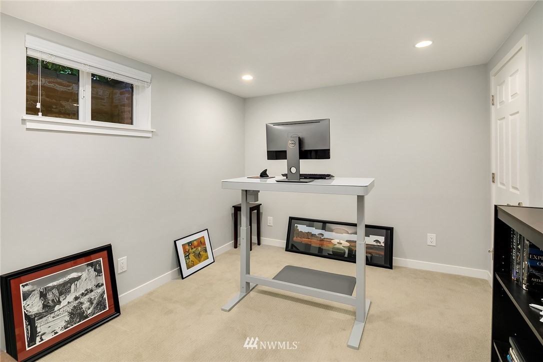 3704 West Dravus Street Seattle, WA 98199 - Photo 29 of 35 a living room with furniture a fireplace and a flat screen tv