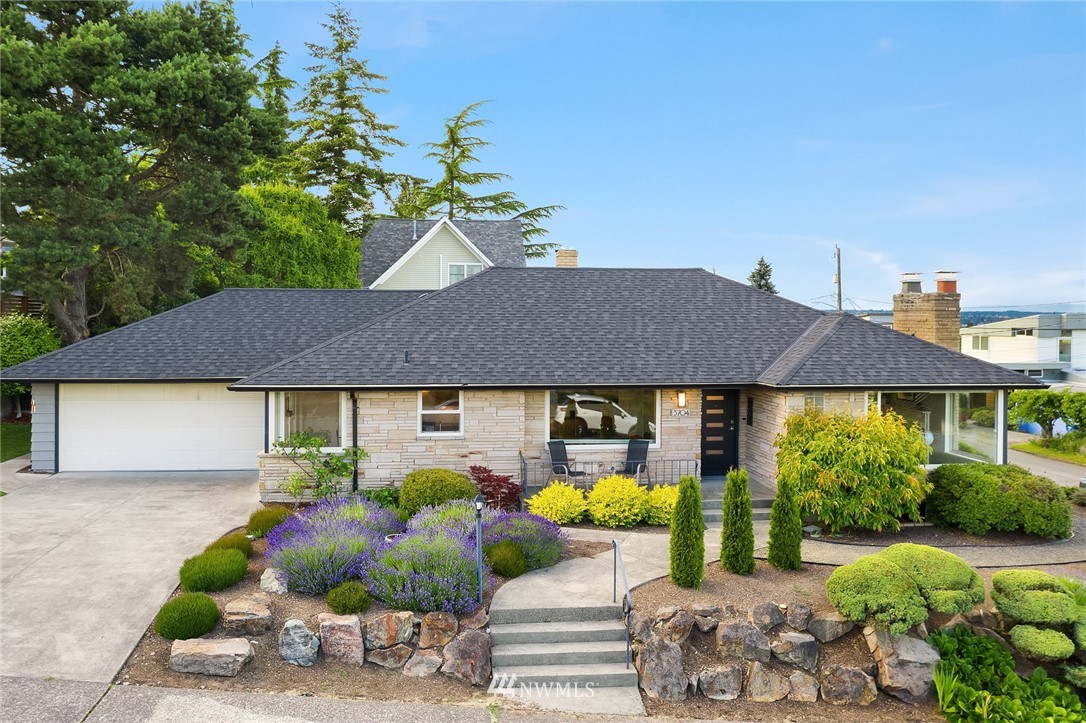 3704 West Dravus Street Seattle, WA 98199 - Photo 33 of 35 a front view of a house with garden