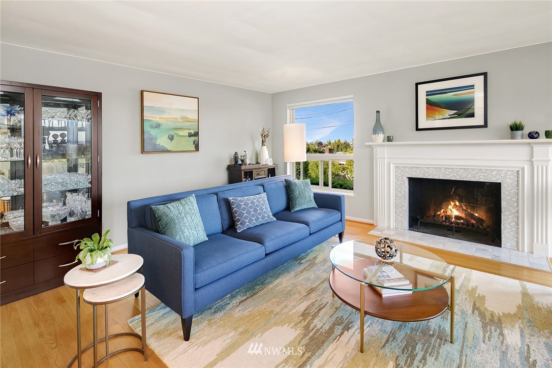 3704 West Dravus Street Seattle, WA 98199 - Photo 5 of 35 a living room with furniture and a fireplace