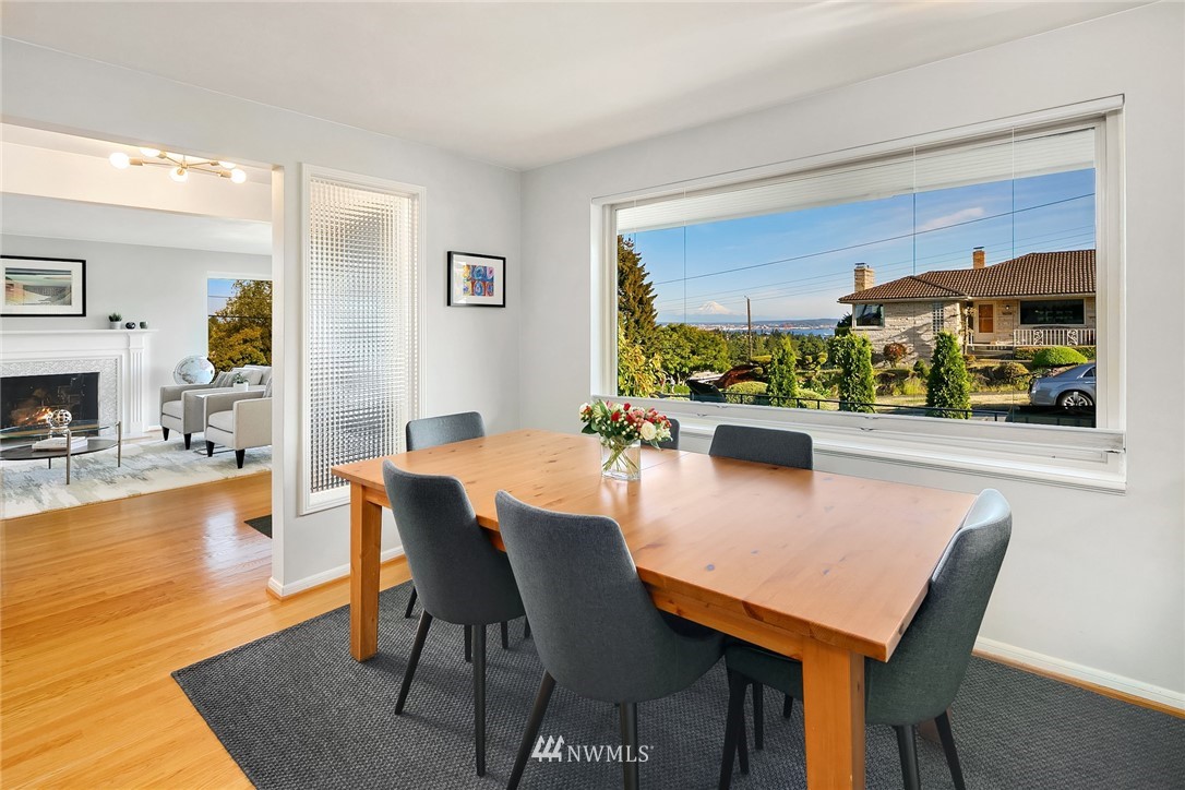3704 West Dravus Street Seattle, WA 98199 - Photo 6 of 35 a view of a dining room with furniture and a fireplace