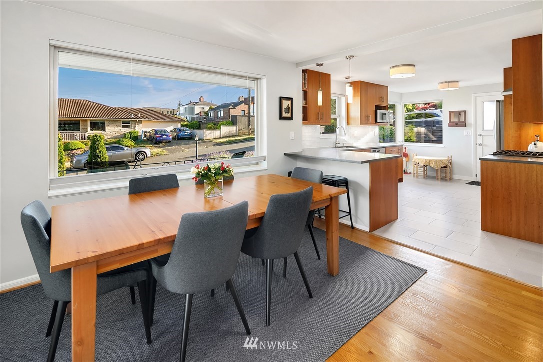 3704 West Dravus Street Seattle, WA 98199 - Photo 7 of 35 a dining area with furniture a kitchen view and a window