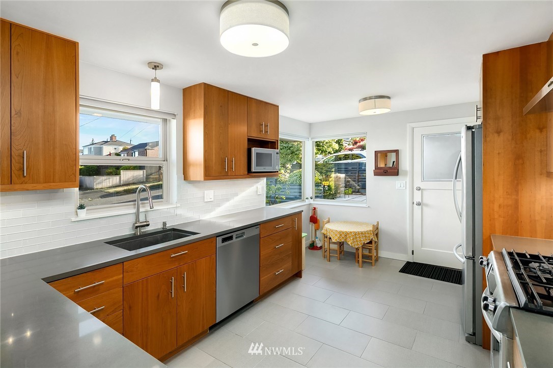 3704 West Dravus Street Seattle, WA 98199 - Photo 8 of 35 a spacious bathroom with a sink double vanity and a mirror
