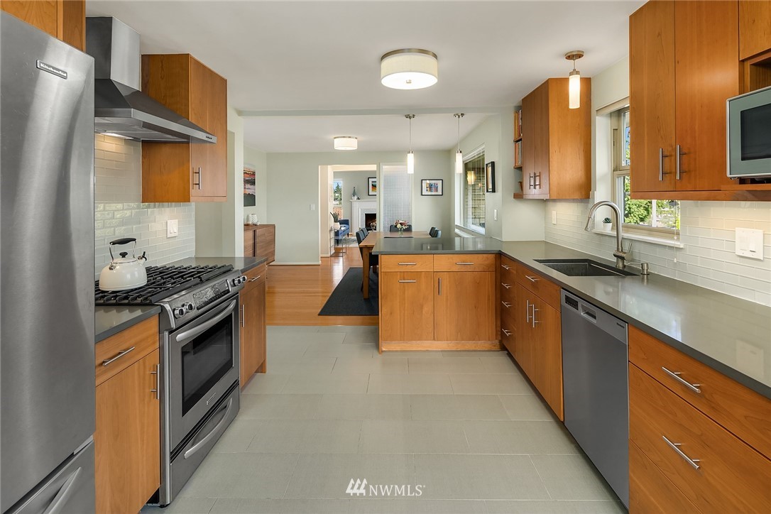3704 West Dravus Street Seattle, WA 98199 - Photo 10 of 35 a large kitchen with stainless steel appliances granite countertop a lot of counter space and a sink