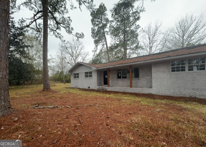 91 Apple Lane Adel, GA 31620 - Photo 1 of 1 a house with trees in the background