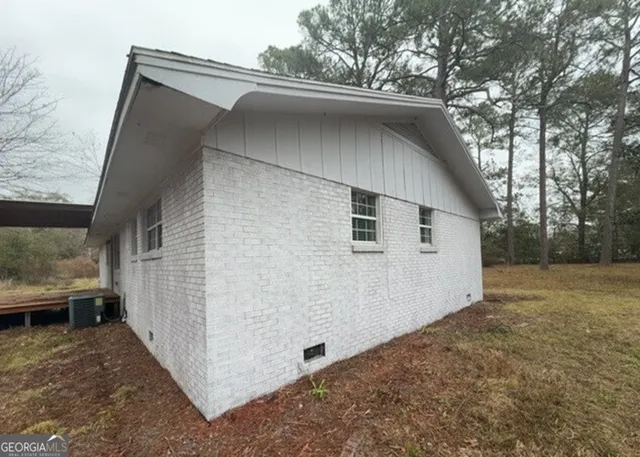 a view of a room with wooden floor and staircase