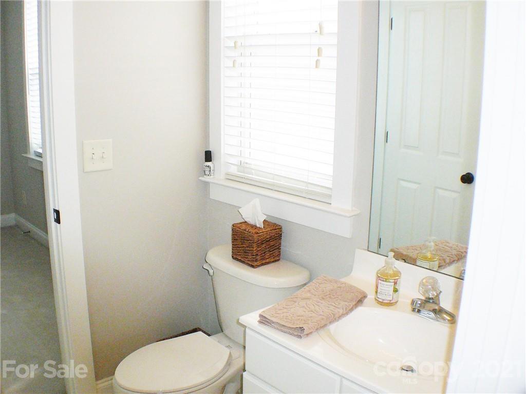 8111 Townley Road Huntersville, NC 28078 - Photo 20 of 27 a bathroom with a toilet sink and mirror