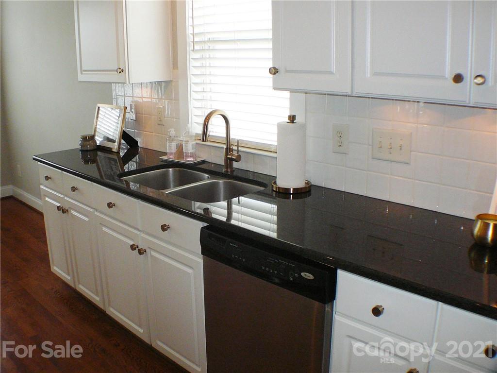 8111 Townley Road Huntersville, NC 28078 - Photo 10 of 27 a kitchen with granite countertop a sink and cabinets