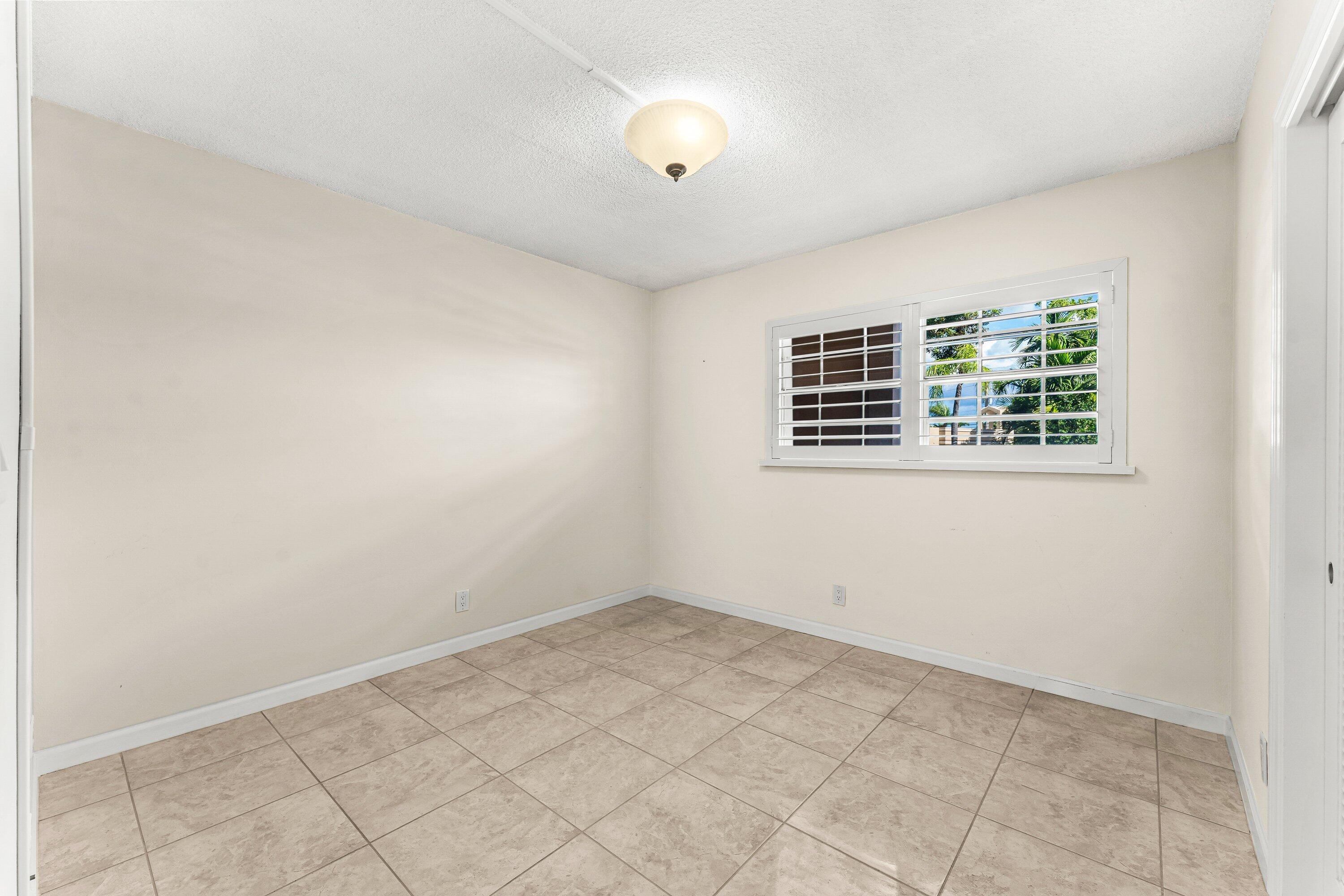 400 Northeast 20th Street, Unit D101 Boca Raton, FL 33431 - Photo 19 of 40 an empty room with windows