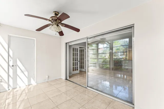 a view of a livingroom with a ceiling fan and window