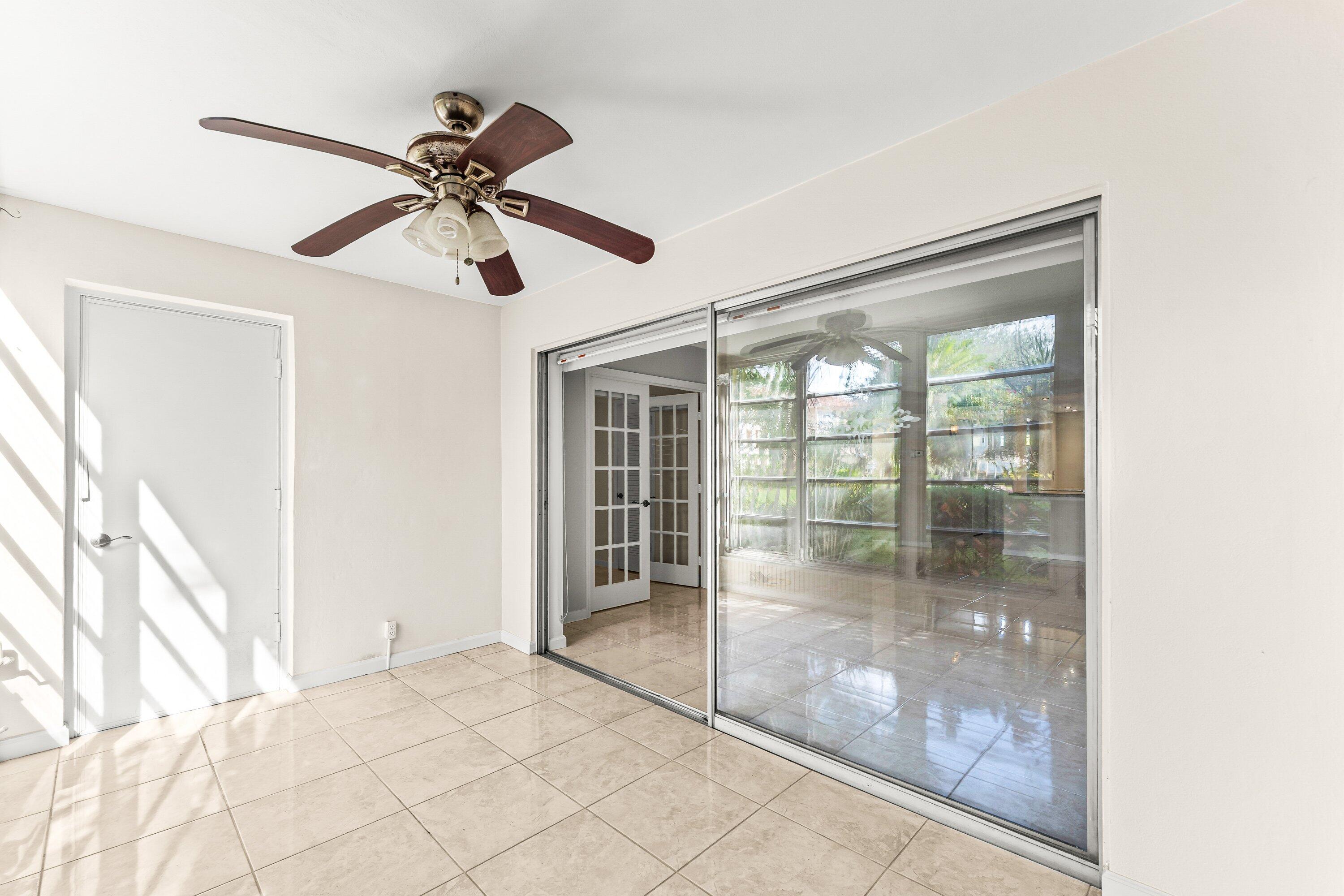 400 Northeast 20th Street, Unit D101 Boca Raton, FL 33431 - Photo 22 of 40 a view of a livingroom with a ceiling fan and window