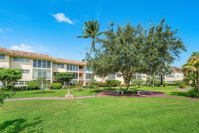 a front view of building with yard and green space