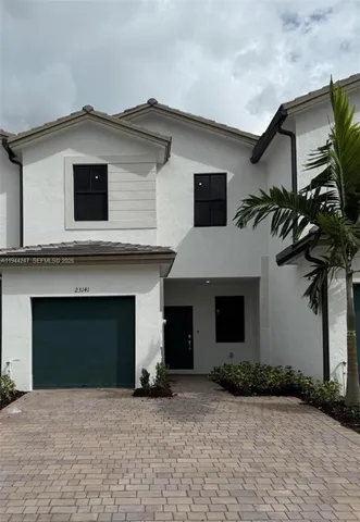 a house that has a tree in front of the house