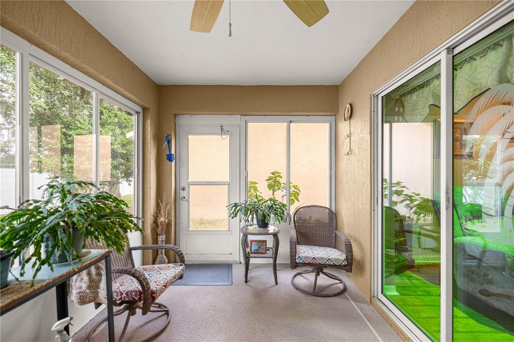 15771 Southwest 13th Circle Ocala, FL 34473 - Photo 14 of 29 a living room with furniture and a floor to ceiling window