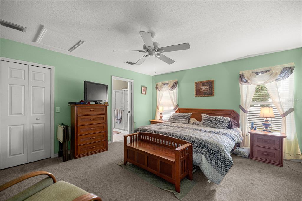 15771 Southwest 13th Circle Ocala, FL 34473 - Photo 15 of 29 a bedroom with a bed and a chandelier