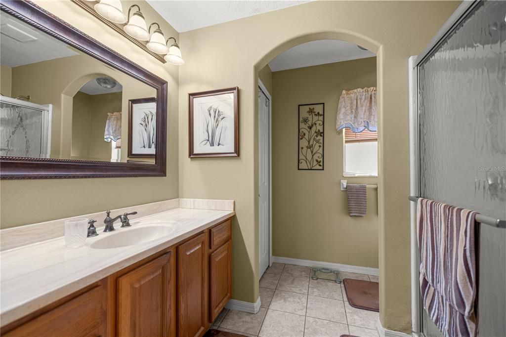 15771 Southwest 13th Circle Ocala, FL 34473 - Photo 17 of 29 a bathroom with a sink and mirror