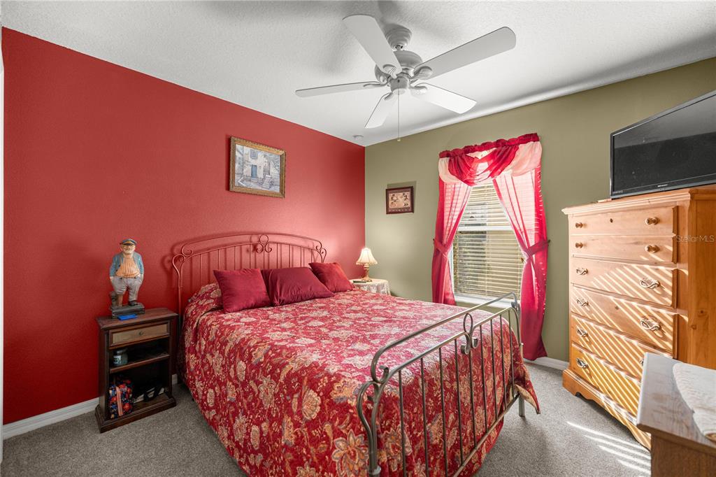15771 Southwest 13th Circle Ocala, FL 34473 - Photo 20 of 29 a bedroom with a bed and a flat screen tv