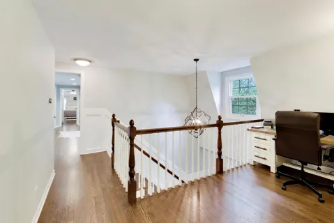 a bedroom with a bed and a chandelier fan