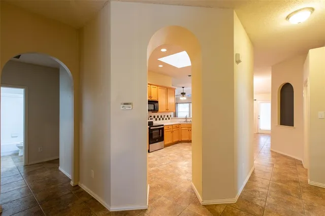a view of a living room with a tub and wooden floor